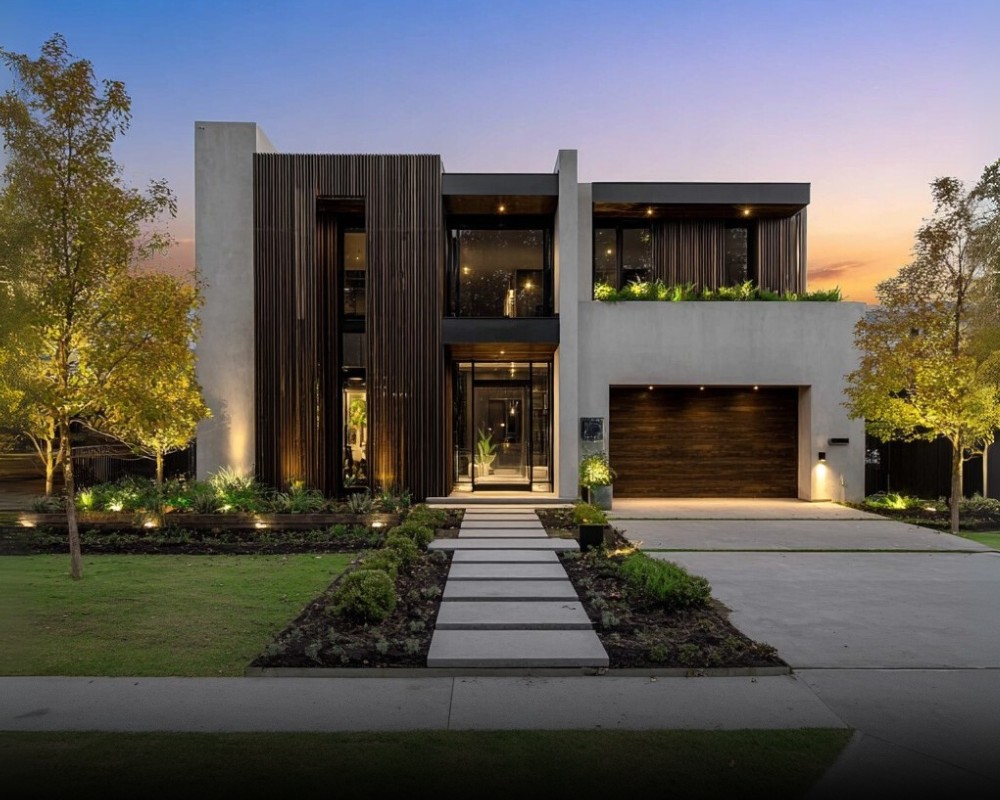 A modern home with a slatted wood and glass facade at dusk